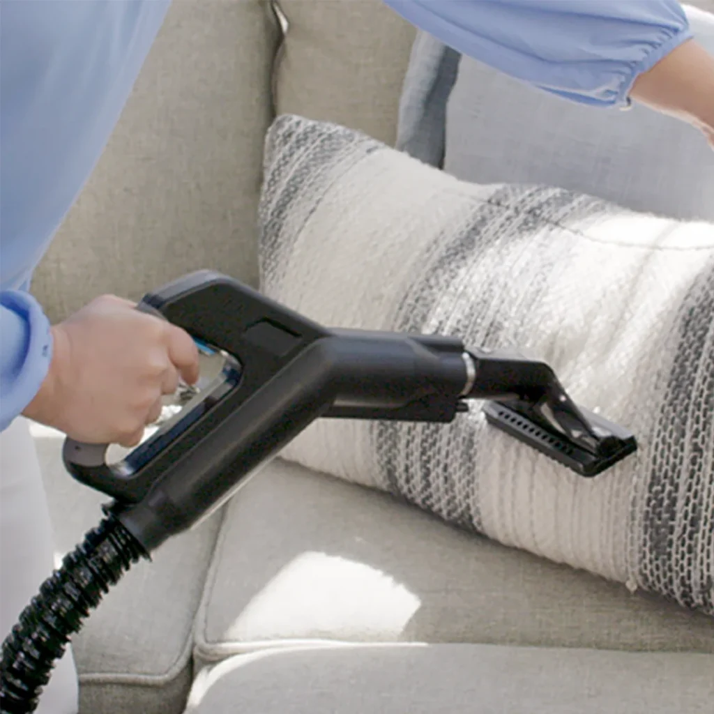 Rainbow vacuum using water filtration to remove dust mites from upholstery